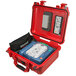 A red Philips watertight hard case with a defibrillator inside.