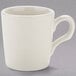 A white Tuxton espresso cup with a handle.