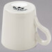 A Tuxton white china espresso cup with a handle.
