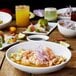 A table with a white oval slanted porcelain bowl filled with food.