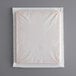 A white foam brick with a plastic wrapper.