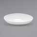 A Front of the House white oval porcelain bowl on a gray background.