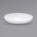 A Front of the House white porcelain oval bowl on a gray surface.