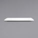 A white rectangular Front of the House porcelain plate on a gray surface.