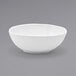 A Front of the House white oval tall porcelain bowl on a gray surface.