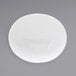 A white oval porcelain bowl with a white rim on a white surface.