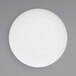 A white Front of the House porcelain plate with a circular design on it.