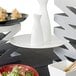A table with a Front of the House white porcelain flat plate of food on it.