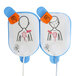 A package of two Defibtech child electrode pads with drawings of children on them.