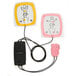 A black rectangular package with pink and yellow cords for child defibrillator pads.