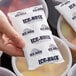 A hand holding a packet of Polar Tech Ice-Brix.