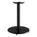 A black Lancaster Table & Seating cast iron table base with a round stand.