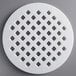 A white circular Fox Run lattice pie crust cutter with holes in it.