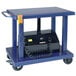 A blue Wesco Industrial Products battery-powered lift table with a black box on it.