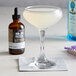 A glass of liquid next to a bottle of 18.21 Bitters.