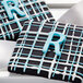 close-up of a black and white square with blue and white icing