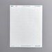 A white sheet of paper with rectangles of white Avery PermaTrack asset labels.