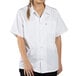 A woman wearing a white Uncommon Chef cook shirt.