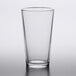 An Arcoroc clear tempered mixing glass with a white background.