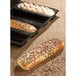 A rectangular loaf of bread with seeds on top in a Sasa Demarle Flexipan Air bread mold.