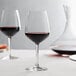 A couple of Arcoroc wine glasses on a table.