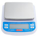 An Avaweigh digital portion scale with a white surface and blue and white rectangular object with white text.