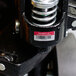 A metal spring with a barcode on an Avery metallic asset label.