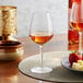 A plate with a glass of Arcoroc wine and strawberries.