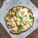 a pizza with eggs and green onions