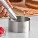 A stainless steel round cake and food ring mold with 'Fat Daddio's ProSeries' branding.