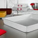 A white rectangular Fat Daddio's cake pan on a counter.