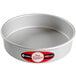 A round silver pan with a red label.