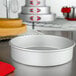 A Fat Daddio's round anodized aluminum cake pan on a counter.