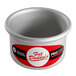 A silver round cake pan with the words "Fat Daddio's Pro" in red and white.