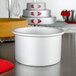 A Fat Daddio's round anodized aluminum cake pan on a table.