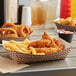 A table with a Carnival King paper food tray holding fried chicken and fries.