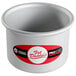 A silver round metal pan with a removable bottom.