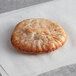 A Father Sam's Bakery small wheat pita pocket bread on white paper.