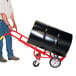 A man using a Wesco hand truck to move a barrel.