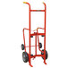 A red Wesco Industrial Products hand truck for steel drums with black rubber wheels.