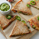 A plate with a quesadilla made with Father Sam's Bakery whole wheat tortilla, with jalapenos on top.