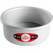a silver bowl with a red and white label