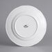 A white Tuxton Chicago china plate with a black logo.