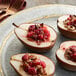 A plate of food with a fork and whole cranberries.