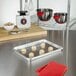 A Fat Daddio's aluminum quarter size sheet pan with cookies on it sitting on a counter.