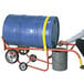 A man using a Wesco drum truck to move a barrel.