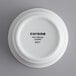 A bright white porcelain ramekin with black text reading "Corona" on it.