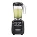 A Hamilton Beach Fury bar blender filled with green liquid.