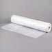 A roll of 100 clear disposable plastic bun pan rack covers.