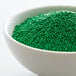 A bowl of green nonpareils.